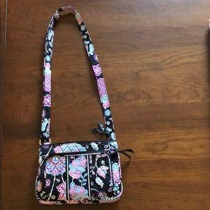 Black purse with multicolored flowers.